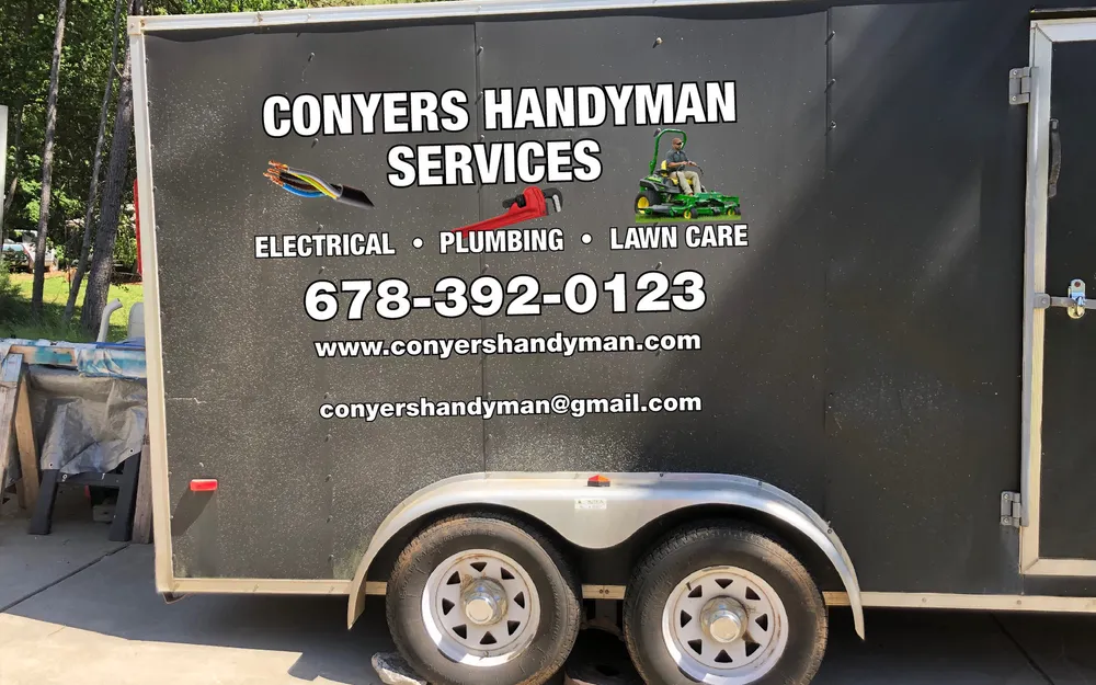 The Conyers Handyman Services work trailer, lettered for electrical, plumbing and lawn care